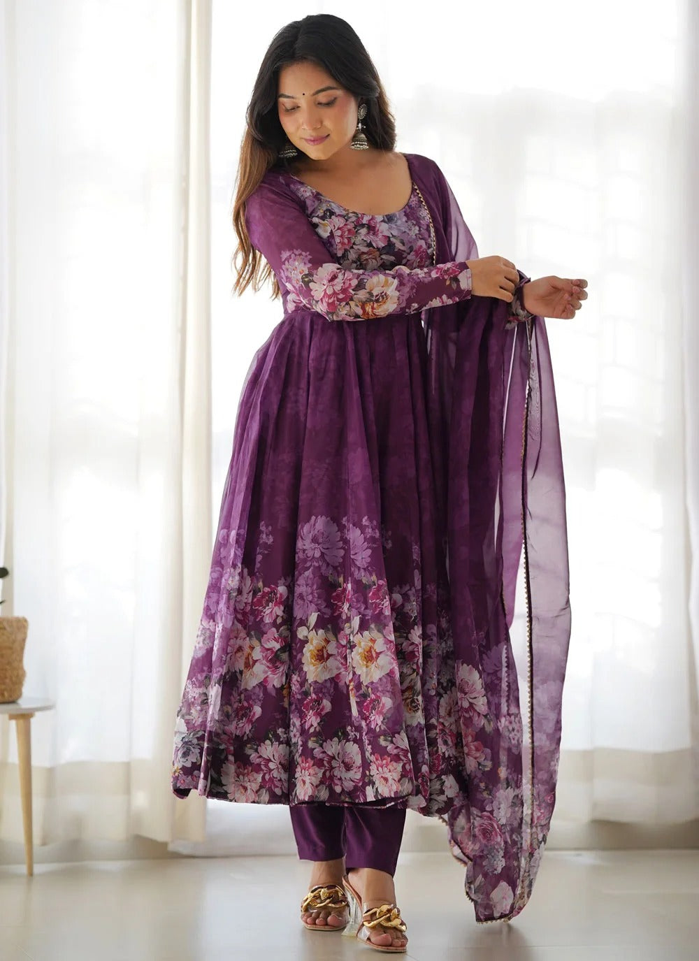 Purple organza Anarkali suit set featuring elegant print, 4-metre kali-cut flare, gota patti lace dupatta and fully stitched pants.
