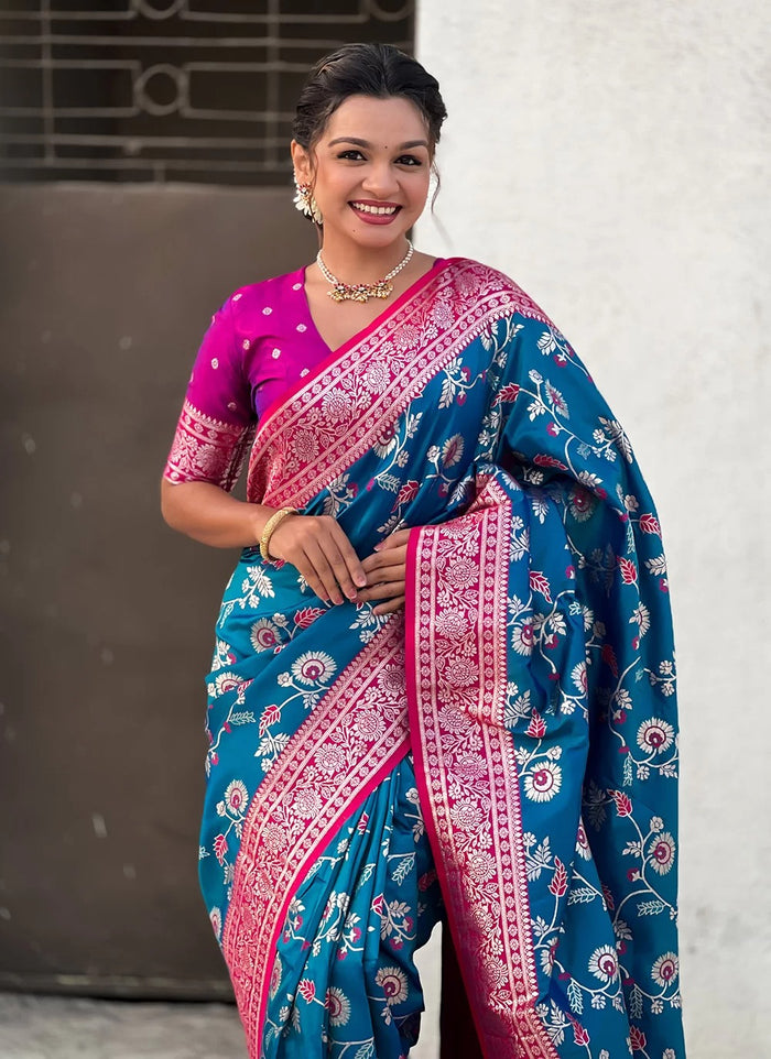 Woman wearing a blue and pink saree with a white background
