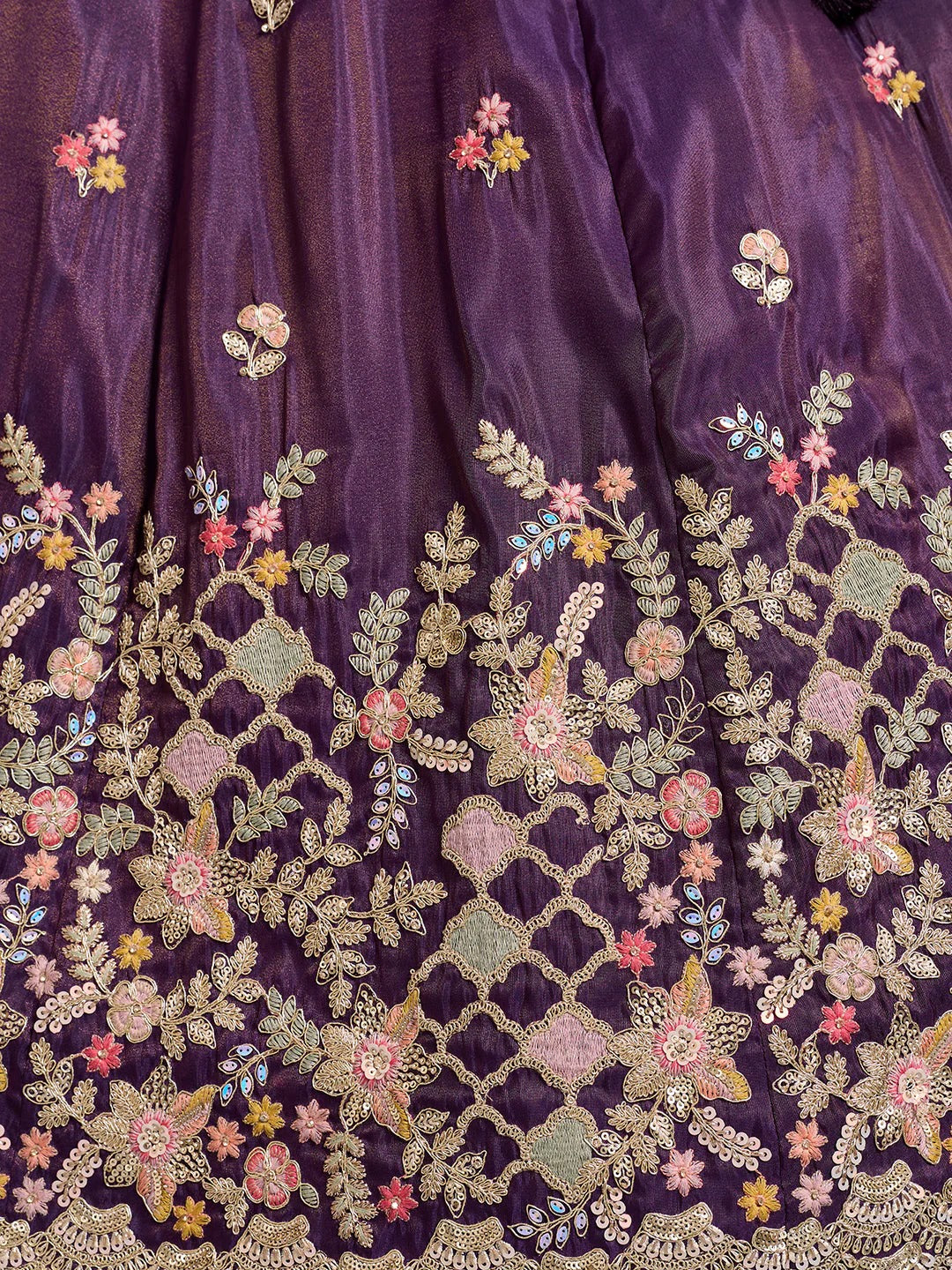 Close-up of purple fabric with floral embroidery
