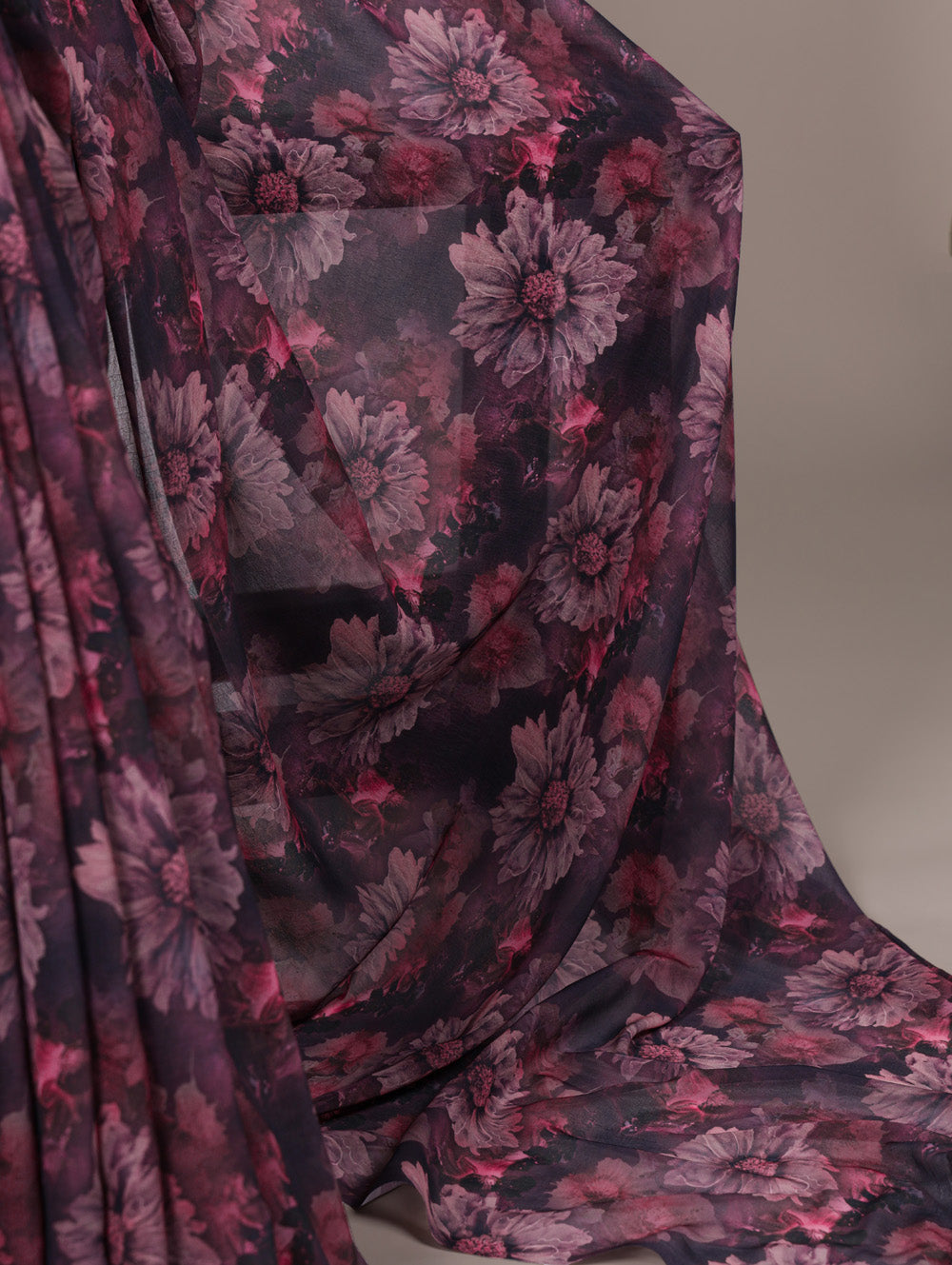 Floral patterned fabric with pink and purple flowers on a dark background