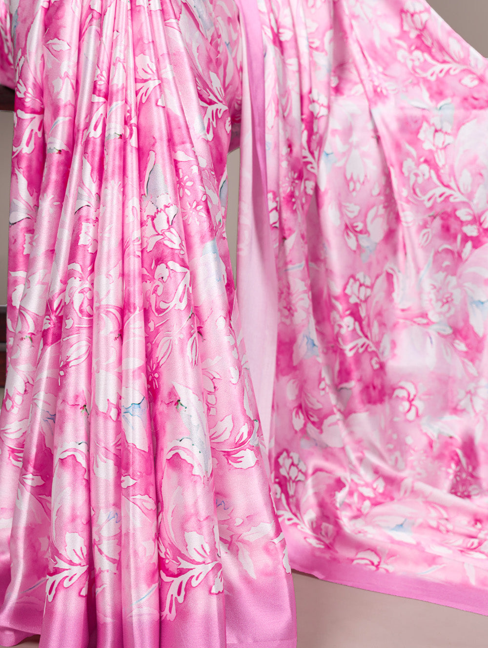 Close-up of pink floral fabric with a soft focus on a neutral background