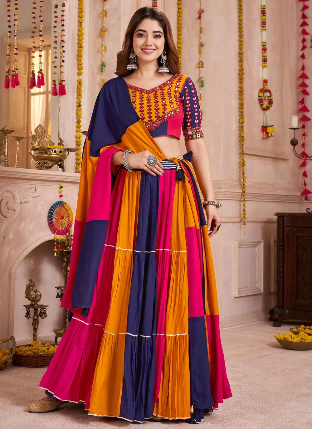 Woman wearing a colorful traditional outfit in an ornate indoor setting