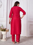 Woman wearing a red kurta with white trim in a minimalistic setting.