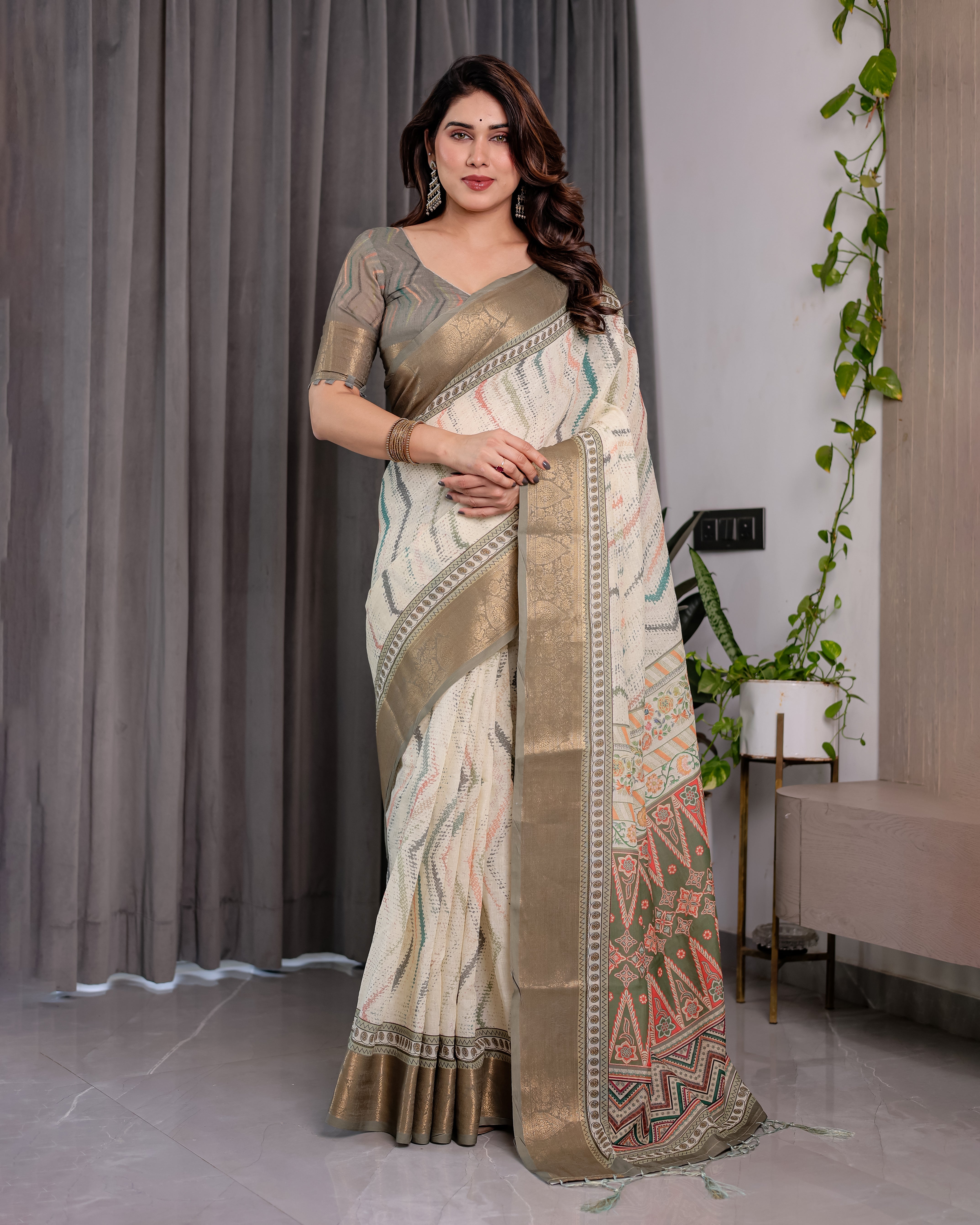 Woman wearing a traditional saree with a patterned design indoors.