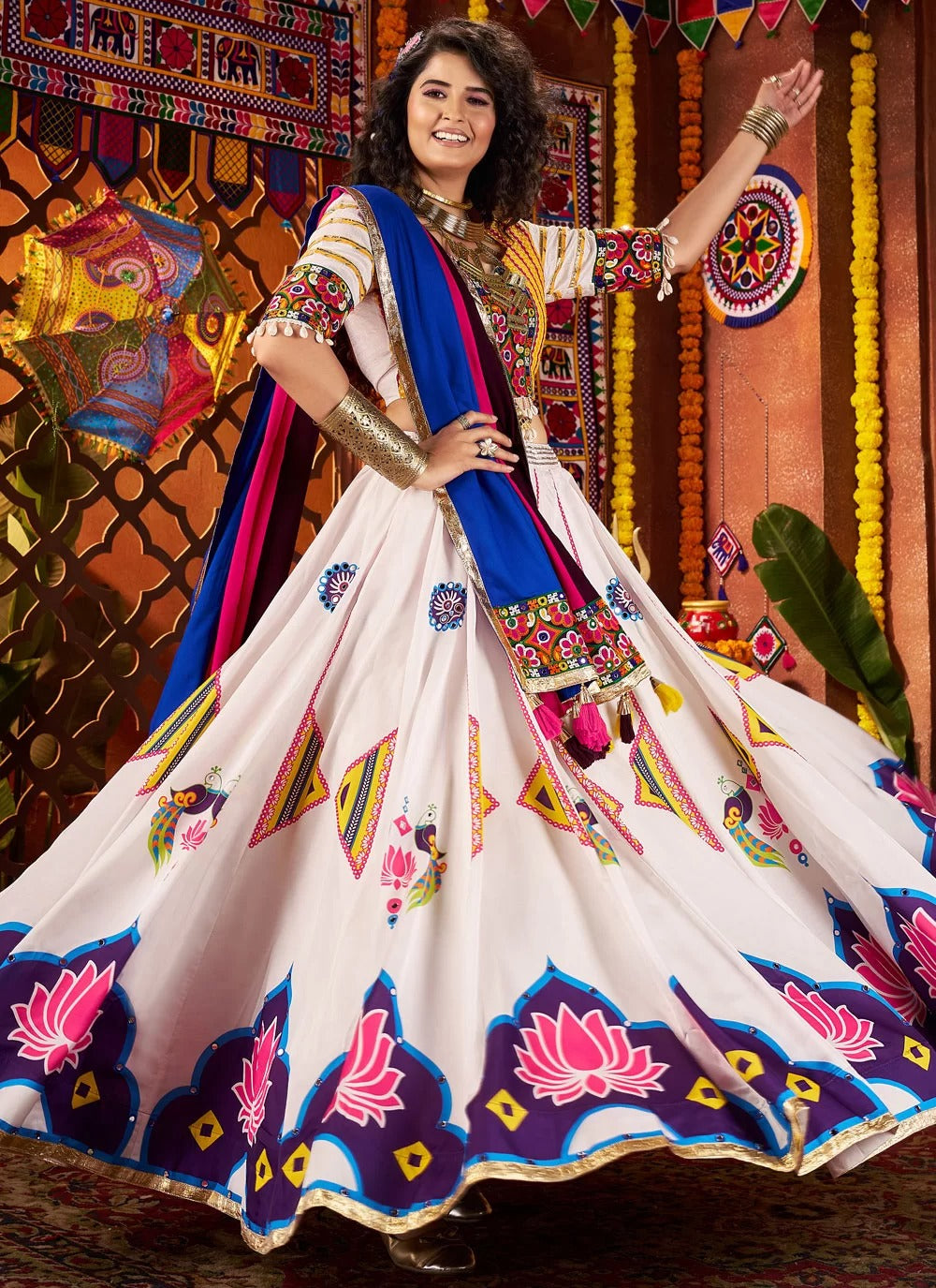 Woman in a traditional embroidered outfit with colorful patterns against a decorative background